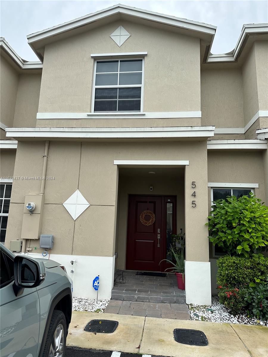 a front view of a house with parking