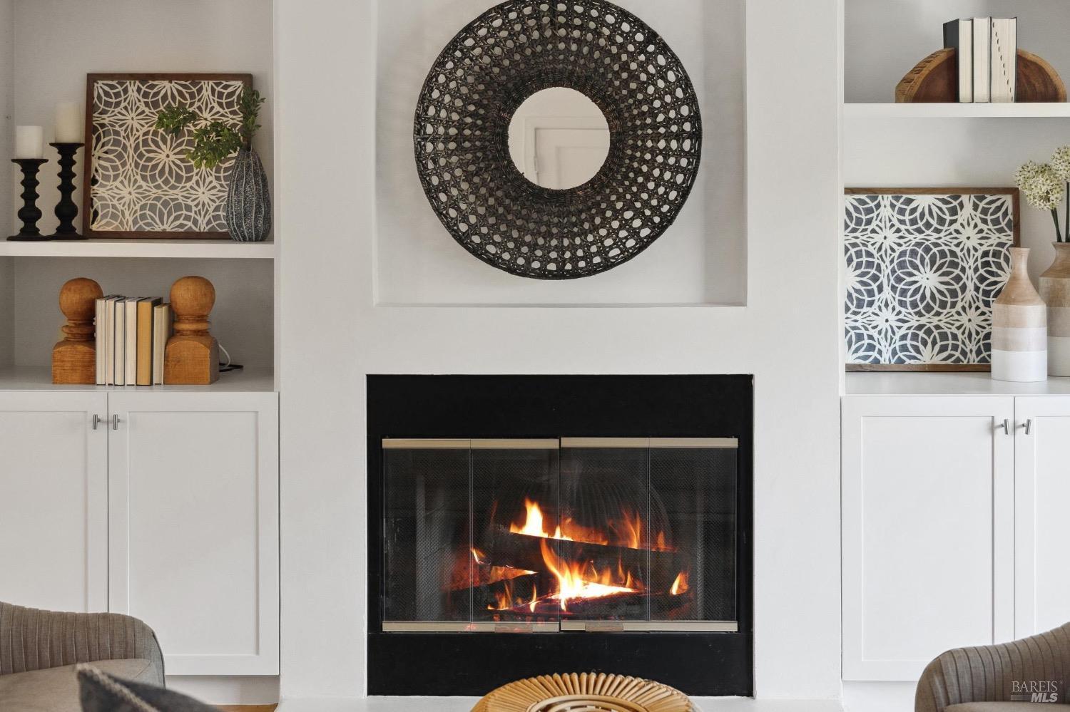 a view of a fireplace with a projector screen on the wall