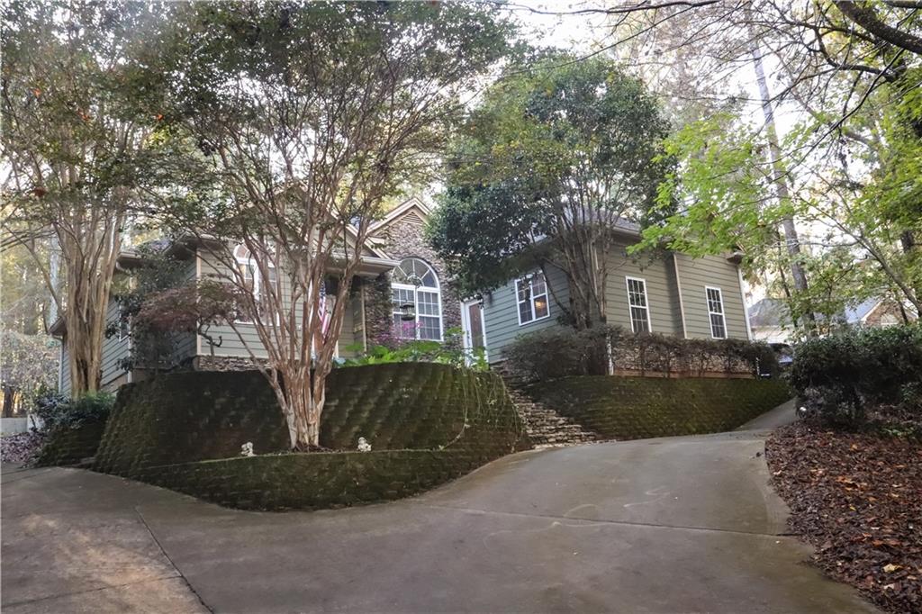 a view of a house with a yard and tree s