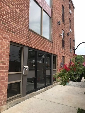 a front view of a building with a garden