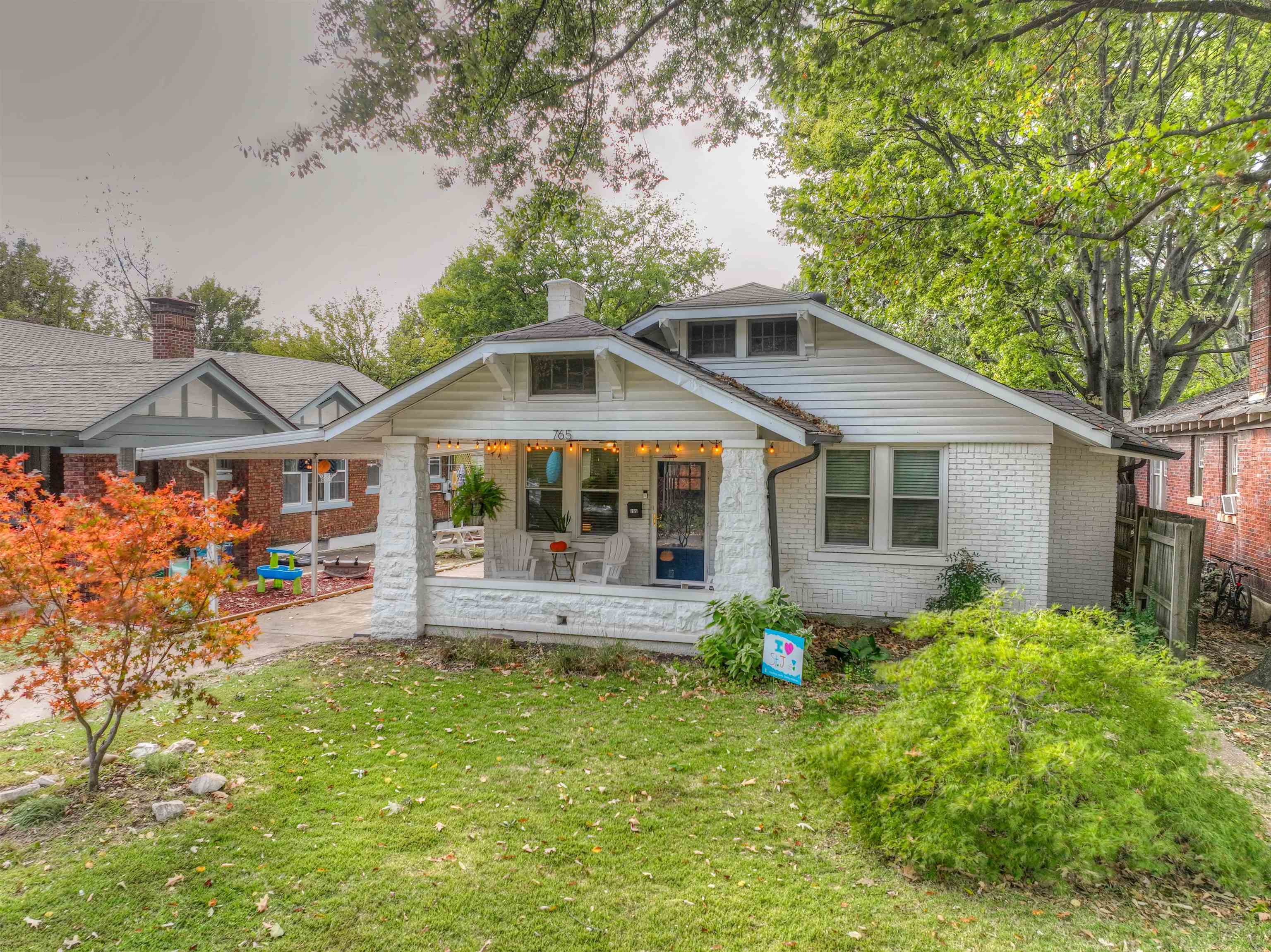 a front view of house with yard and outdoor seating