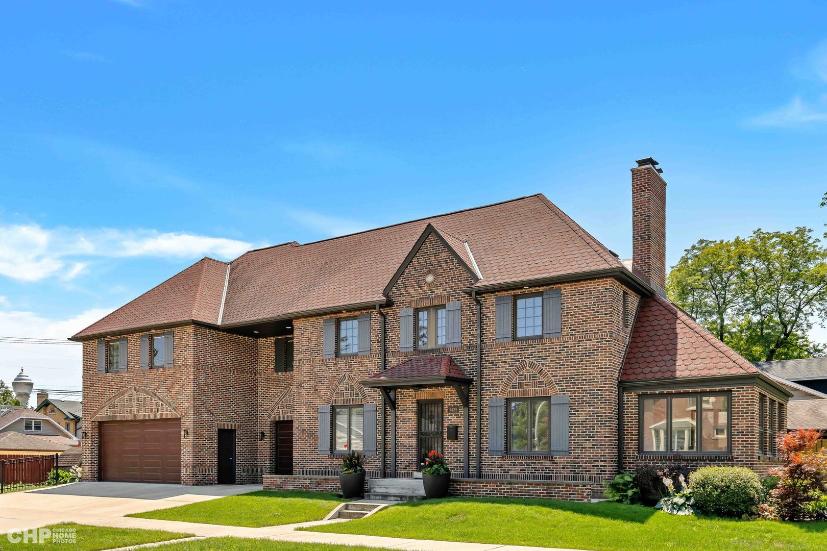 a front view of a house with yard and garage