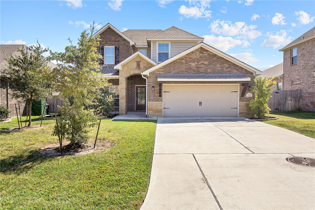 View of front of property with a garage and a fron