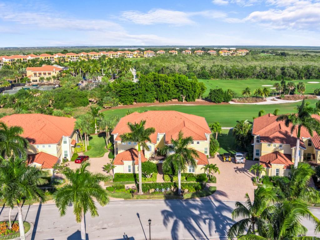 an aerial view of swimming pool with outdoor seating and lake view