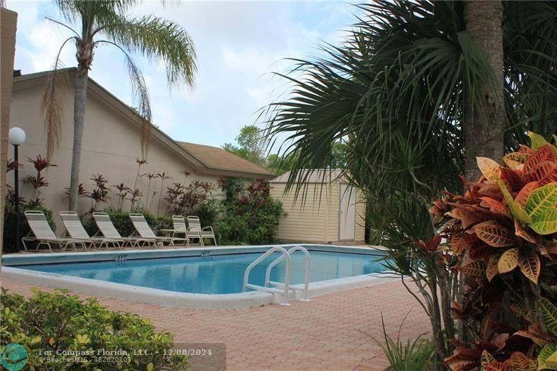 a view of swimming pool with a table and chairs