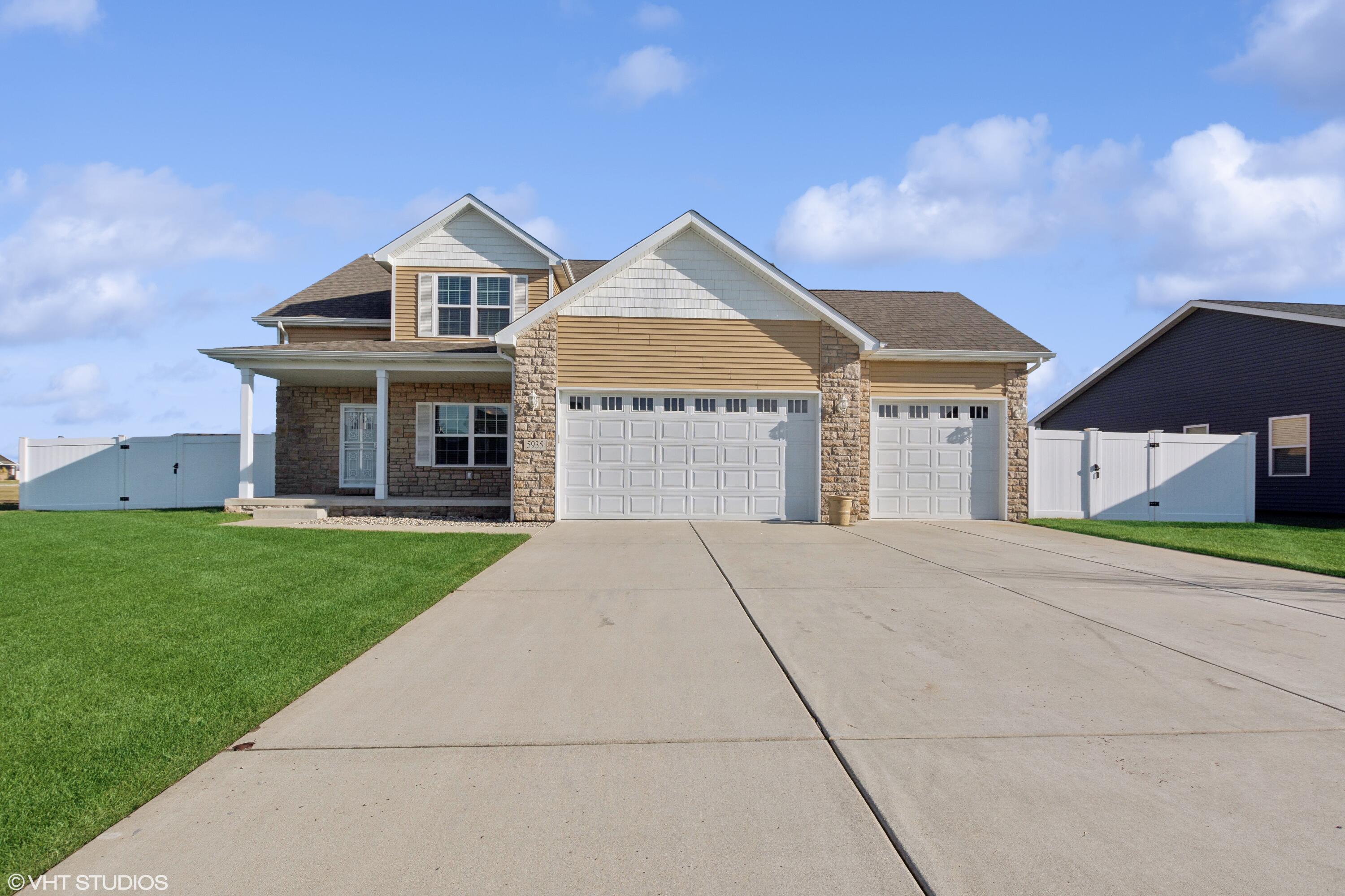 a front view of a house with a yard and garage