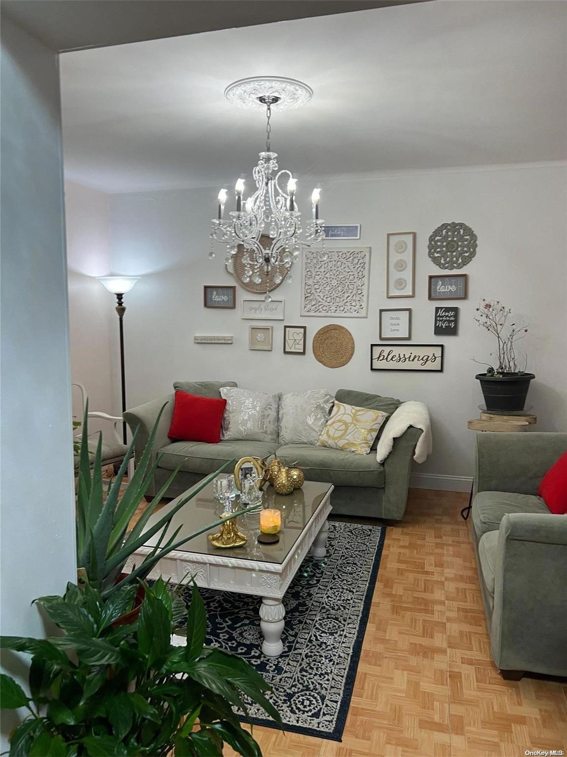 a living room with furniture and a chandelier