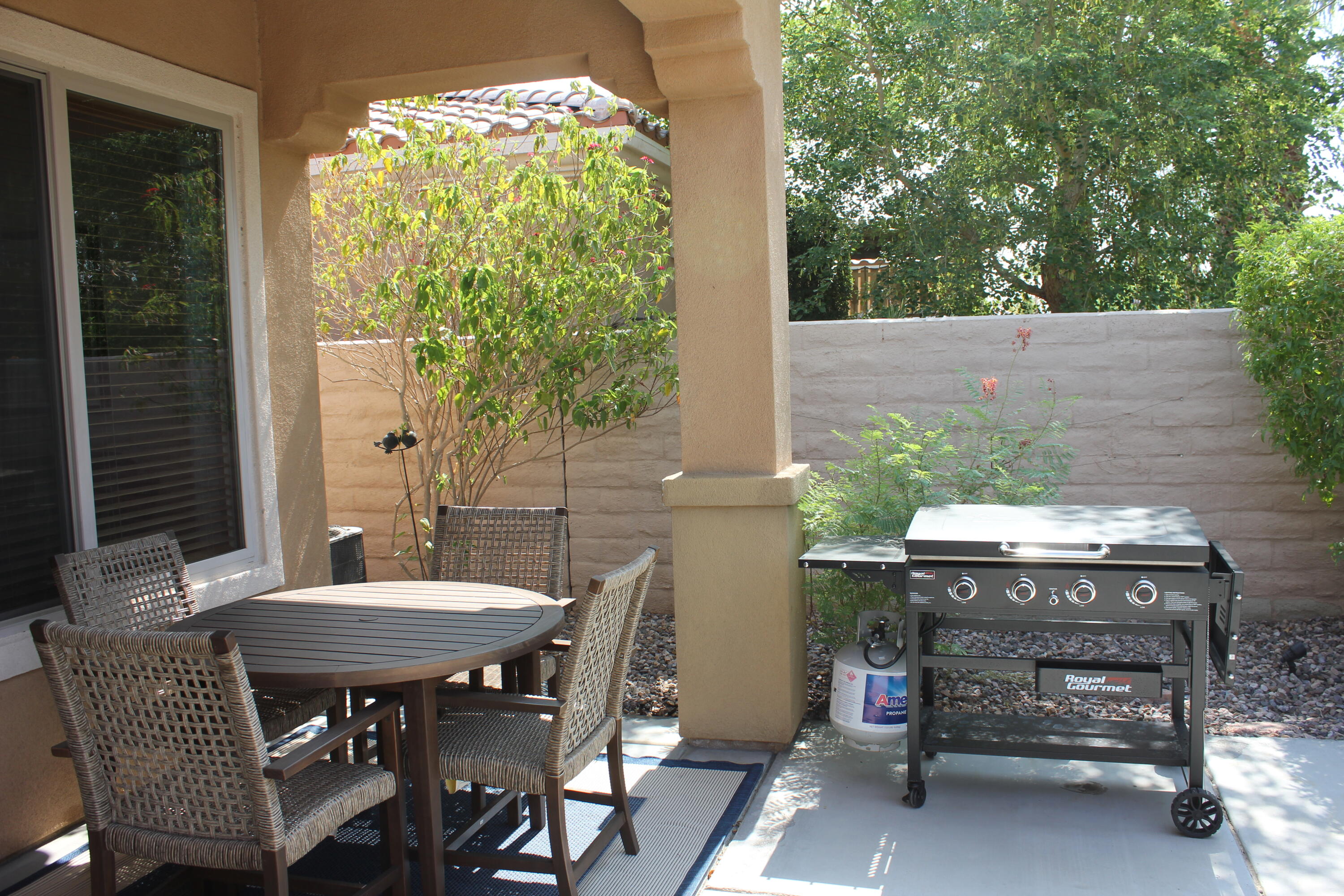 a view of a patio with a table and chairs