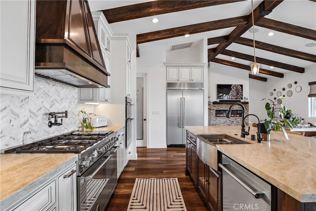 a kitchen with stainless steel appliances granite countertop a stove and a sink