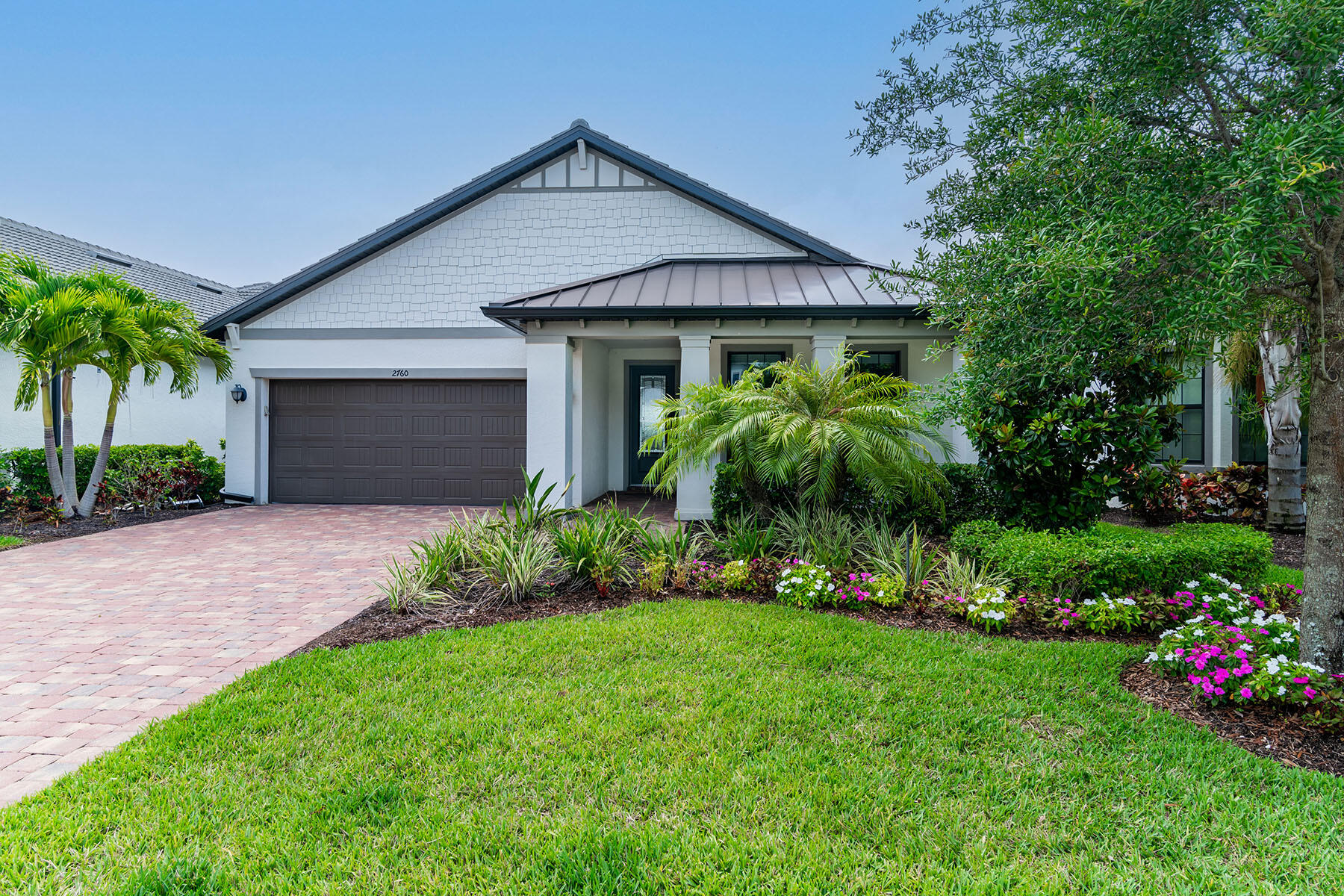 a front view of a house with a garden