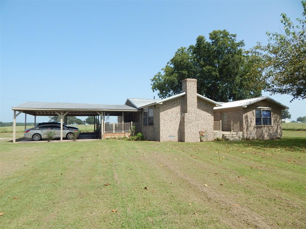 a house with a yard and a large tree