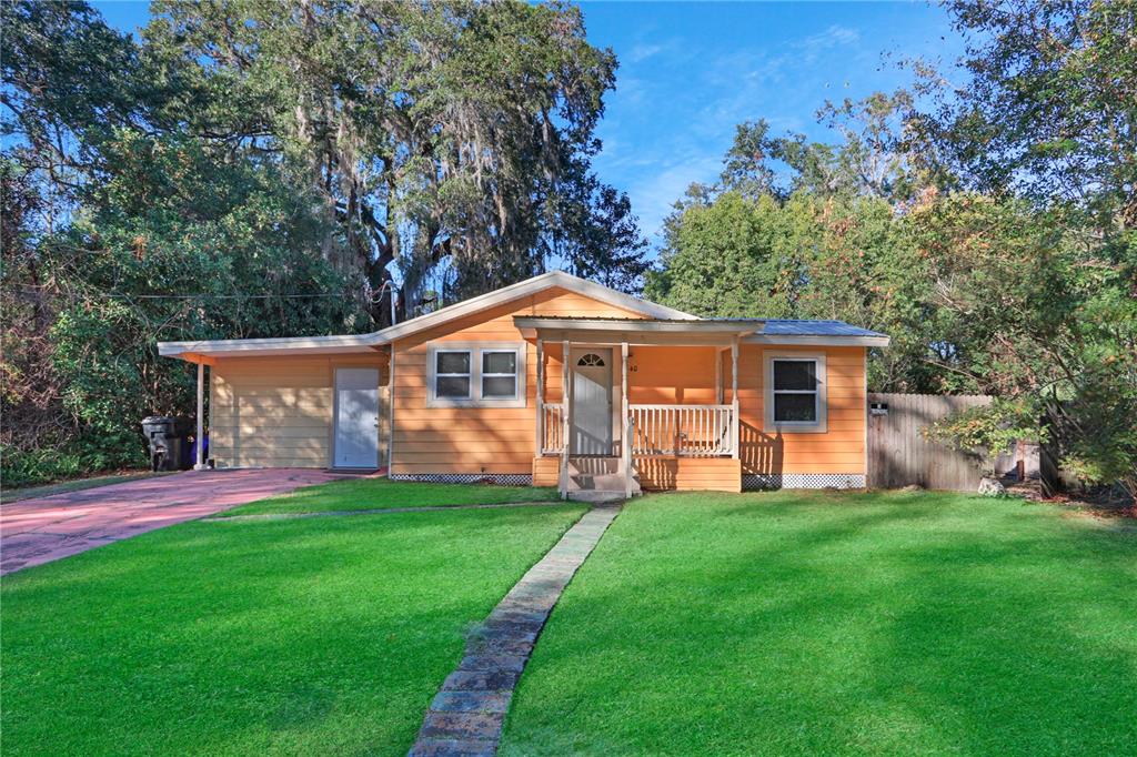 a front view of house with yard and green space