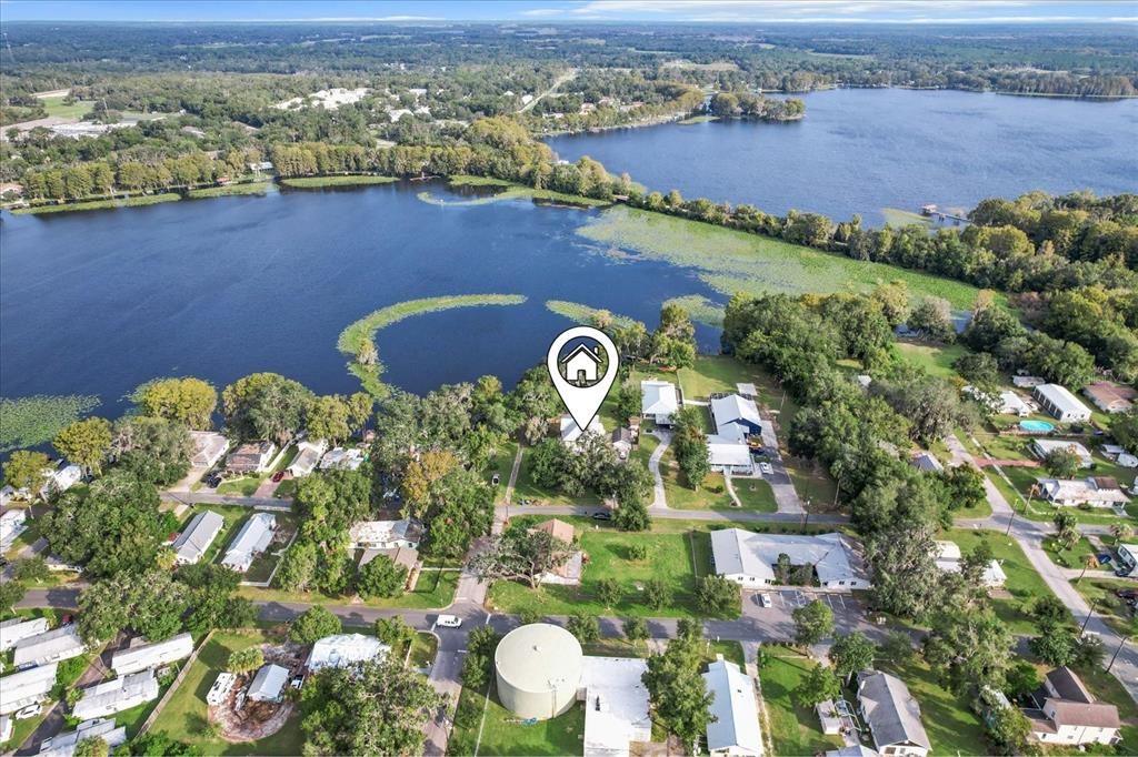 an aerial view of a house with a lake view