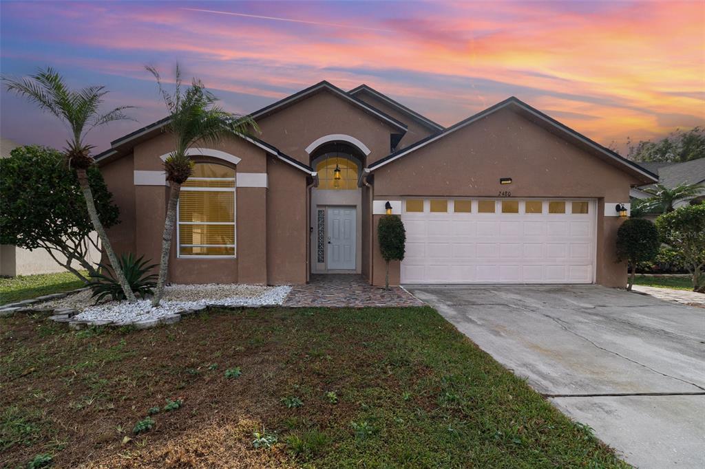 a front view of a house with a yard and garage