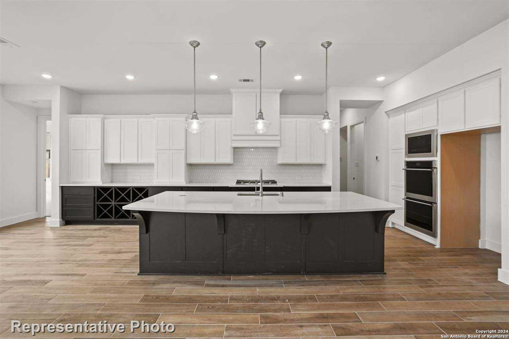 a large kitchen with kitchen island a sink stainless steel appliances and a counter space