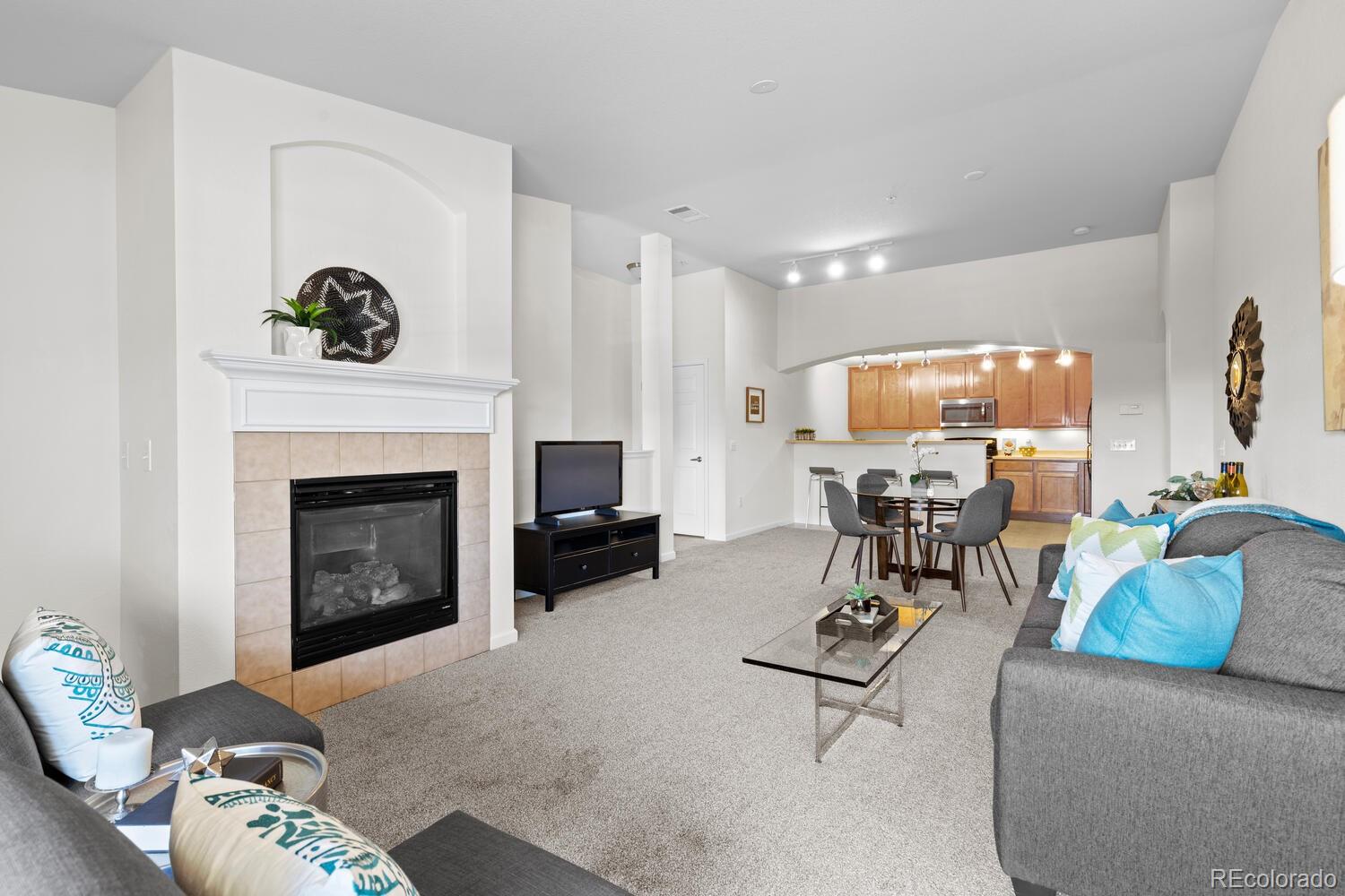 a living room with furniture and a fireplace