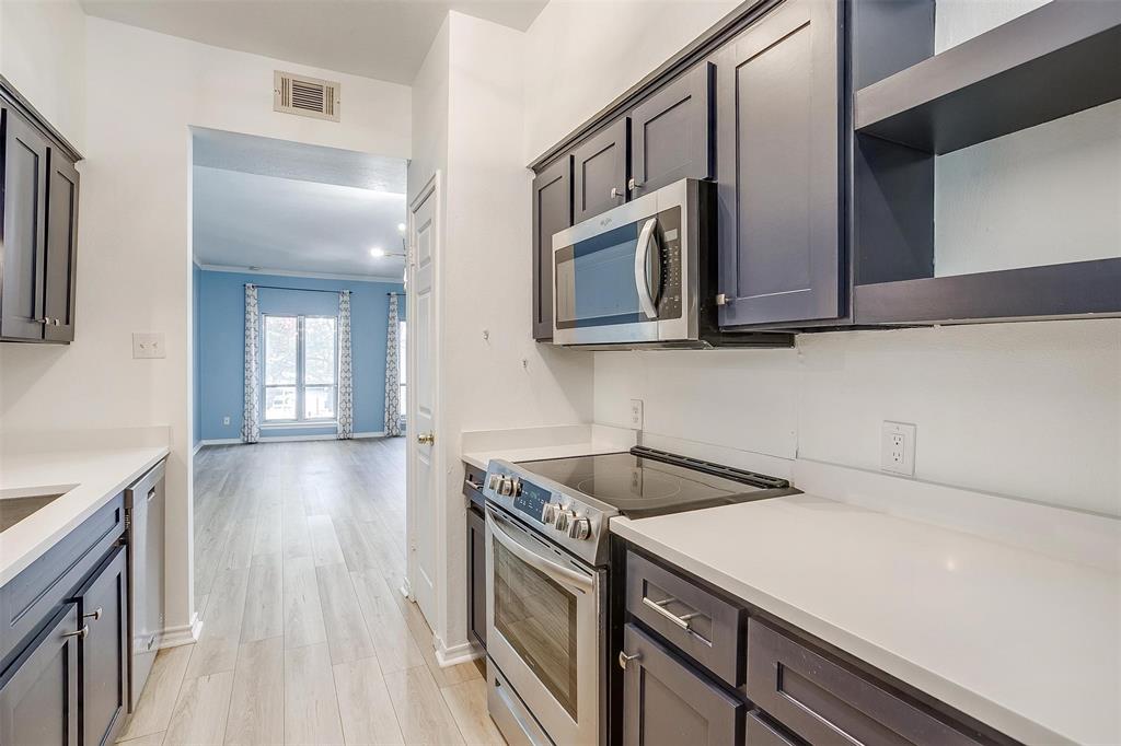 a kitchen with stainless steel appliances granite countertop a sink and a stove top oven