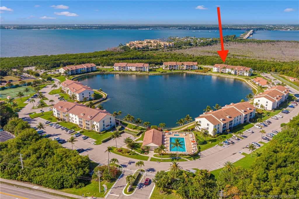 an aerial view of residential houses with outdoor space and ocean view