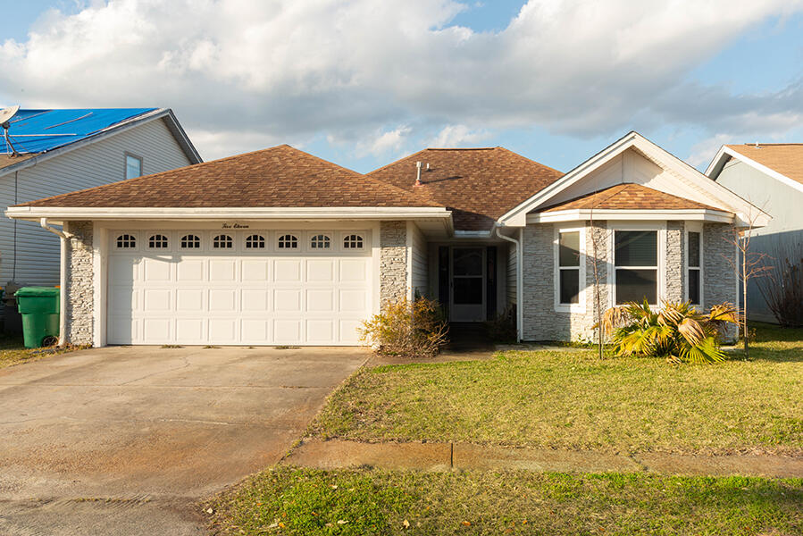 a front view of a house with a garden and porch