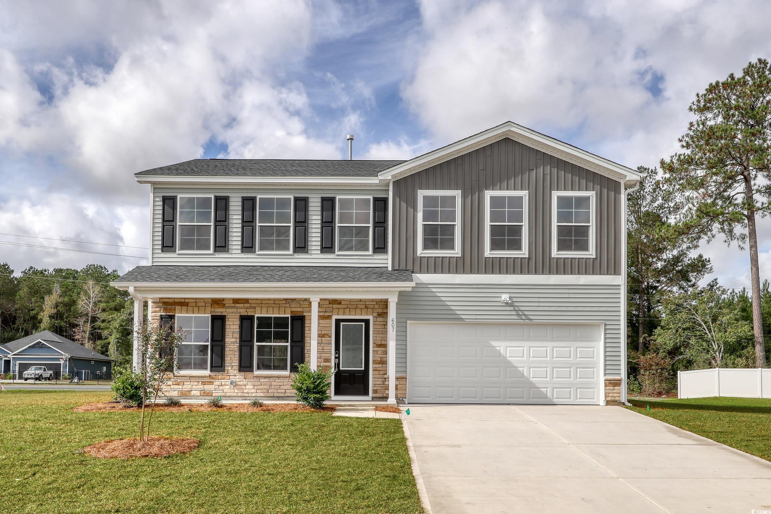 View of front of home featuring a garage and a fro