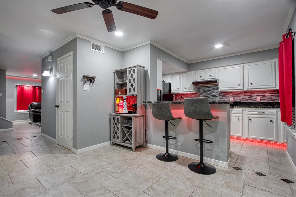 a view of a kitchen with stainless steel appliances kitchen island granite countertop a refrigerator and microwave