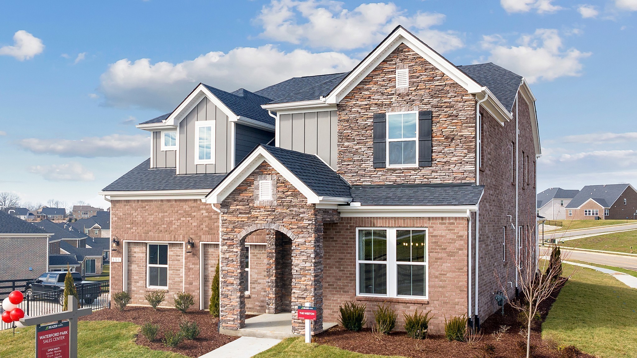 a front view of a house with a yard