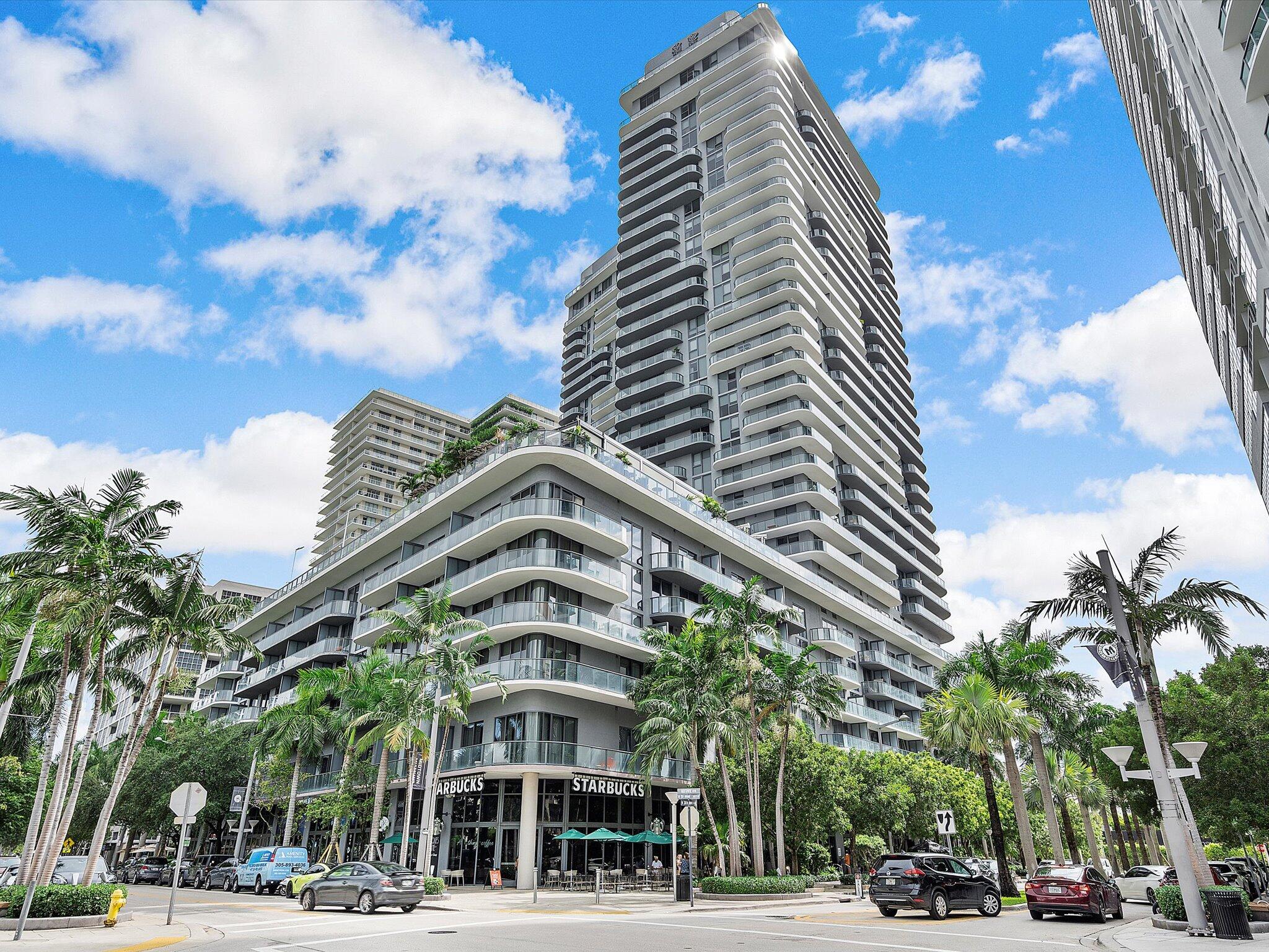 a view of a tall building next to a road