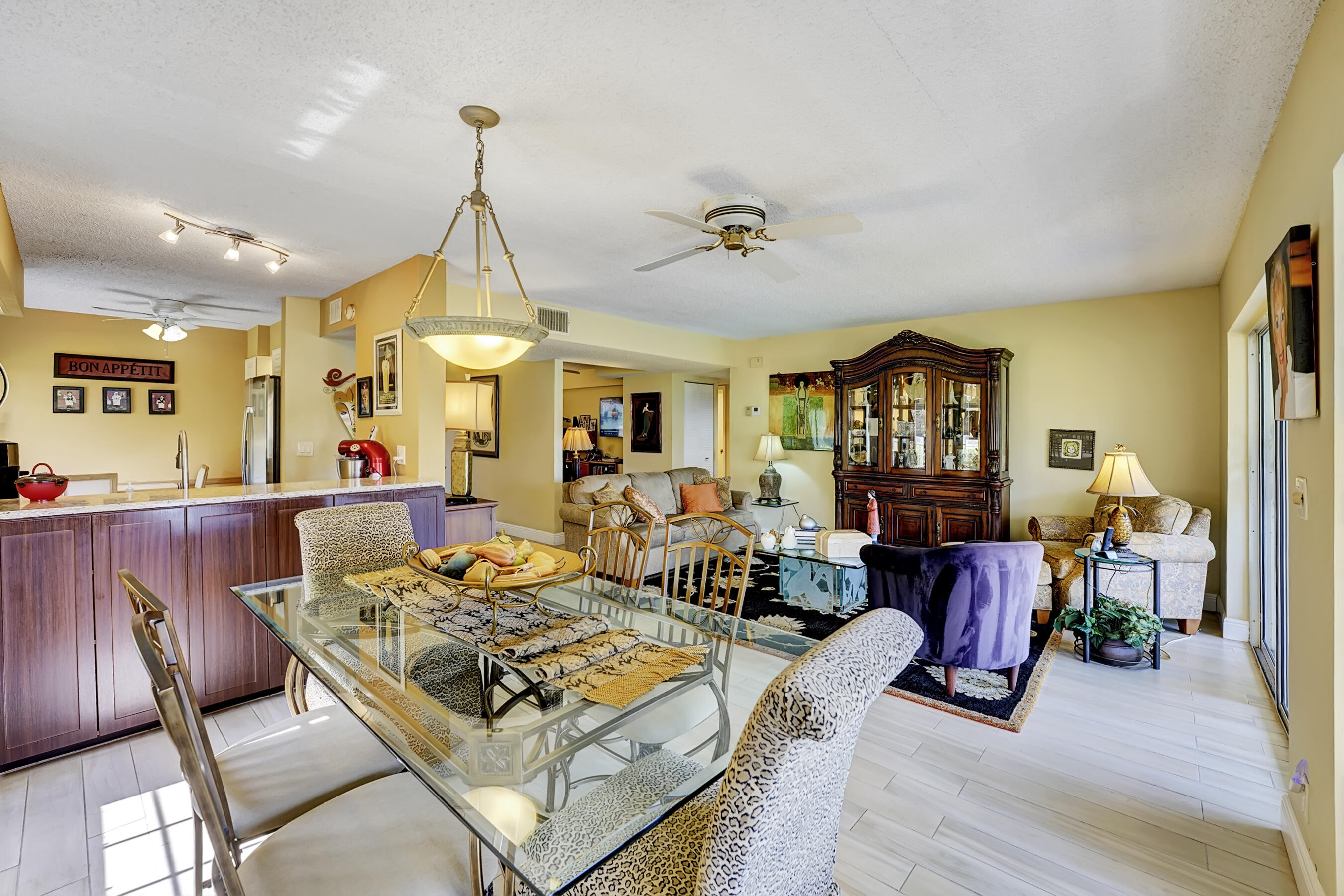 a living room with furniture a wooden floor and a chandelier