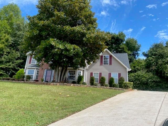 a front view of a house with a yard