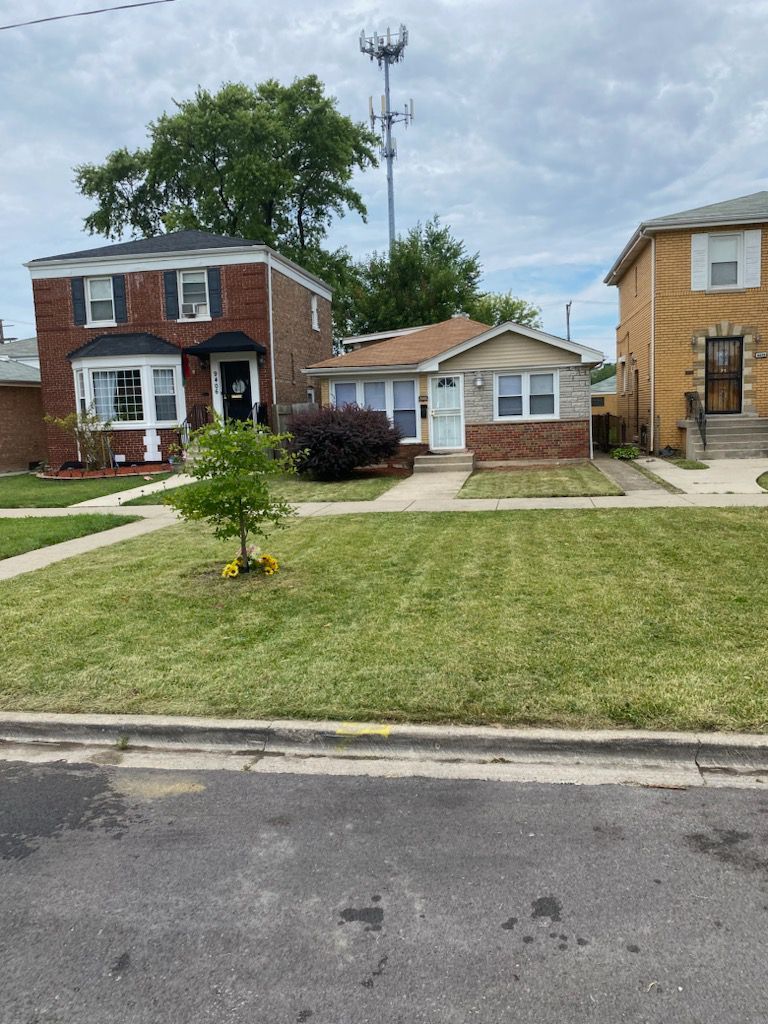 a front view of a house with a garden