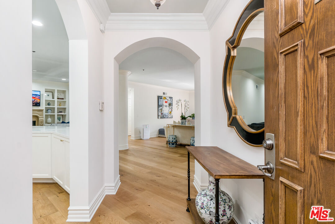 a view of an entryway with wooden floor