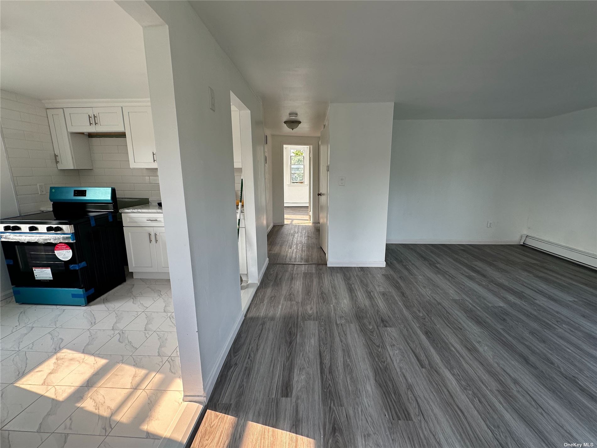 a kitchen with wooden floors and refrigerator