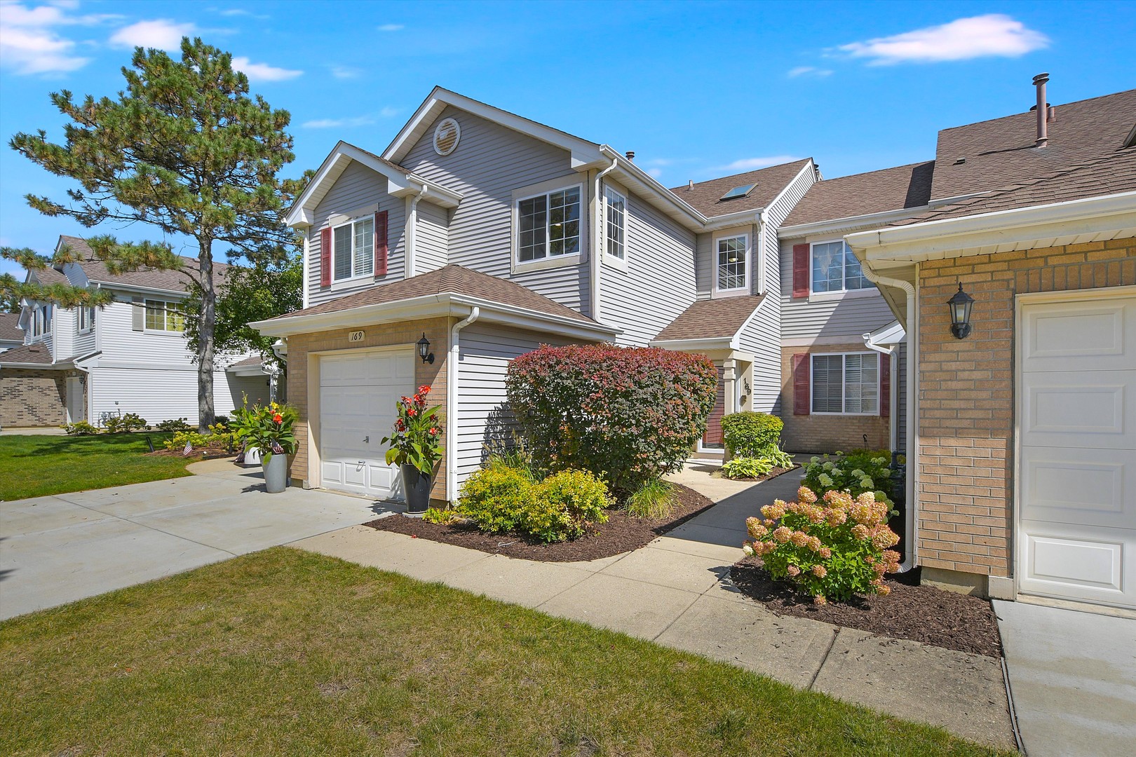 a front view of a house with a yard and a garage