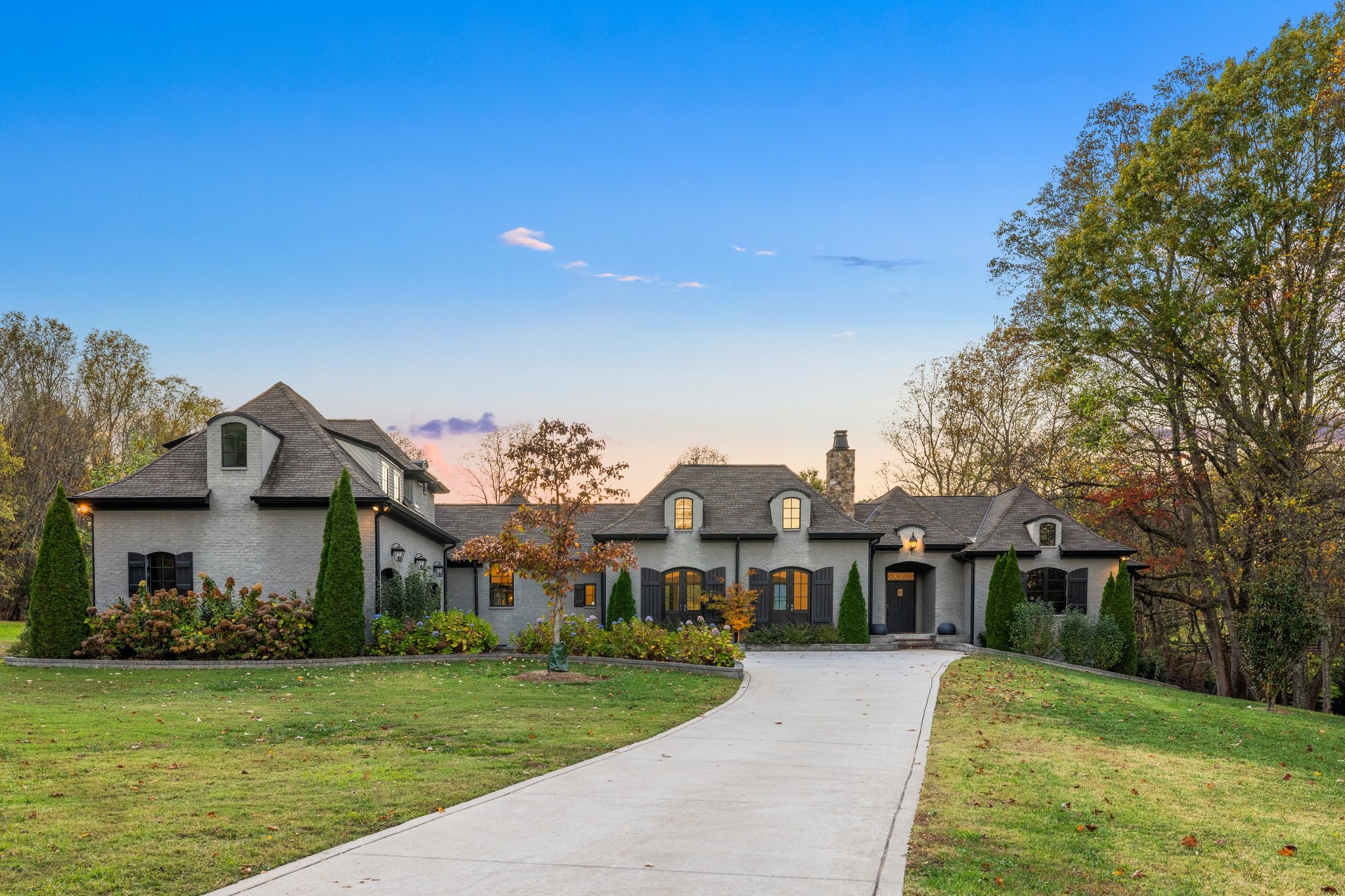 a front view of a house with a garden