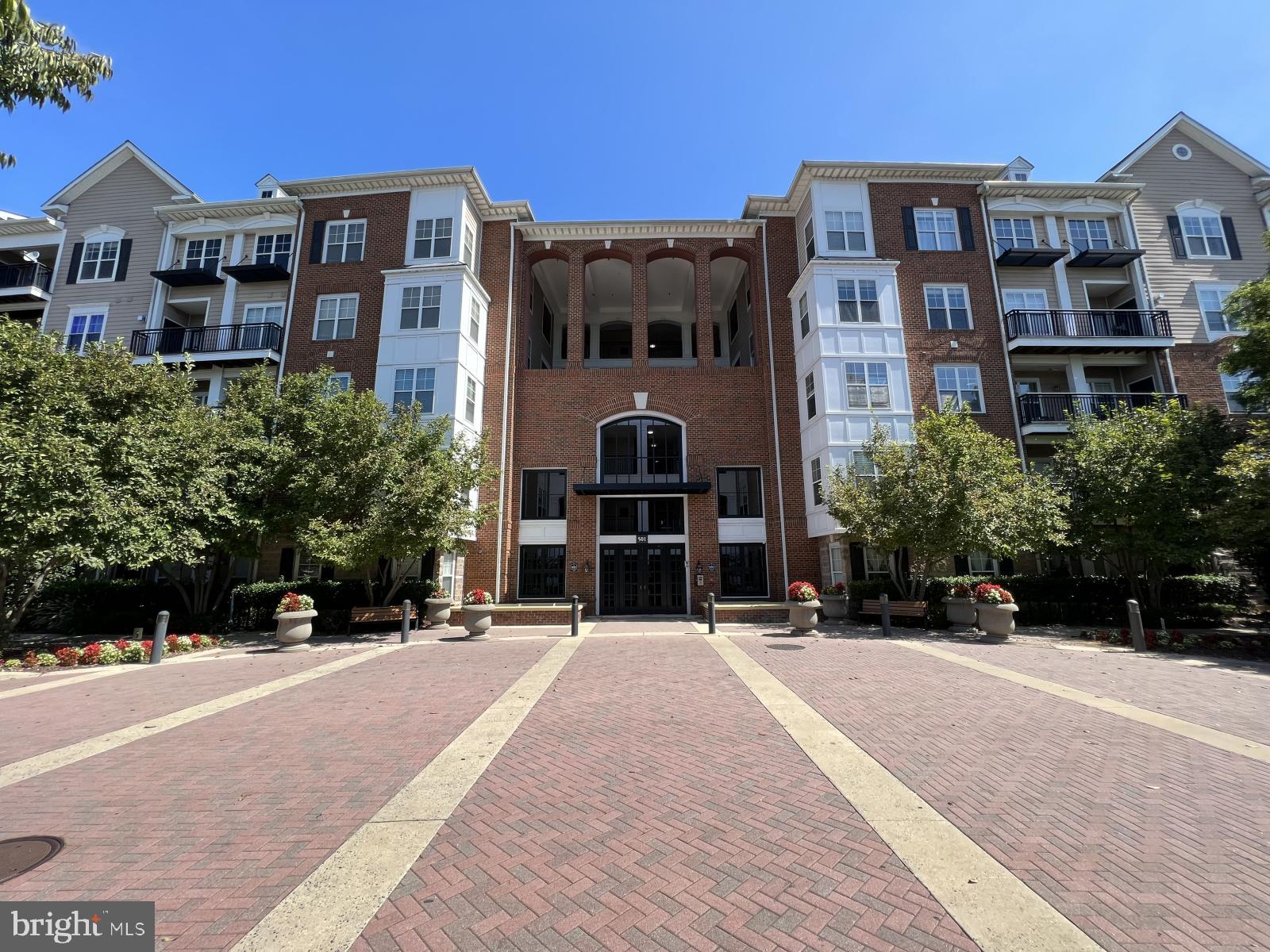 a front view of a building with a garden