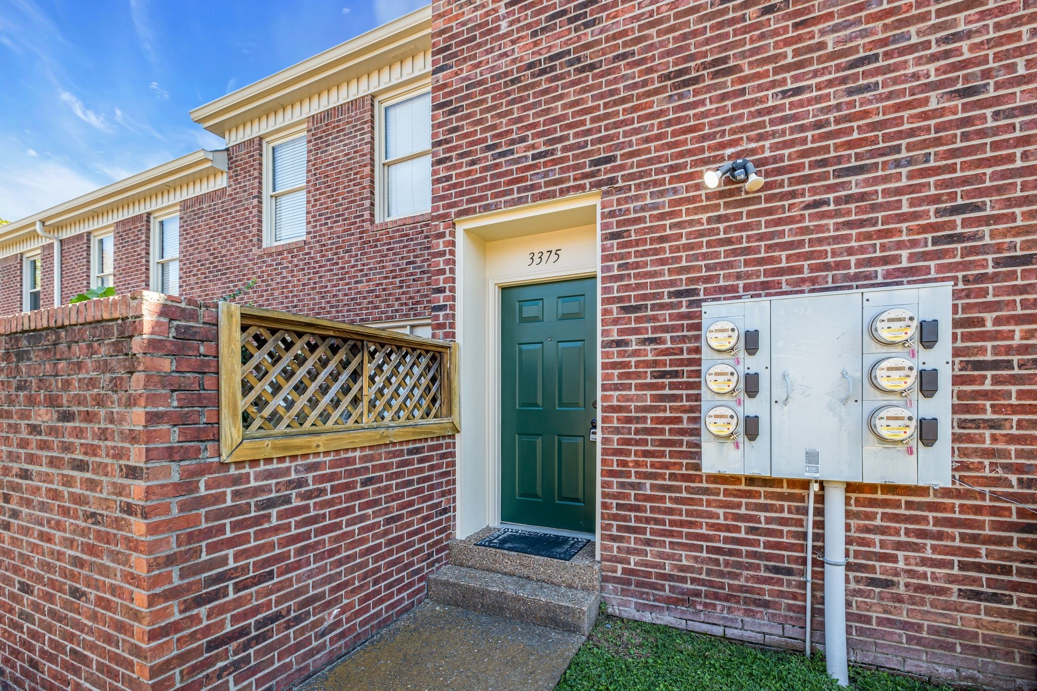 a brick building with a door and a window