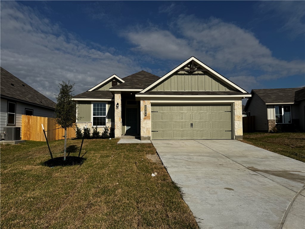 Craftsman house with cooling unit, a garage, and a