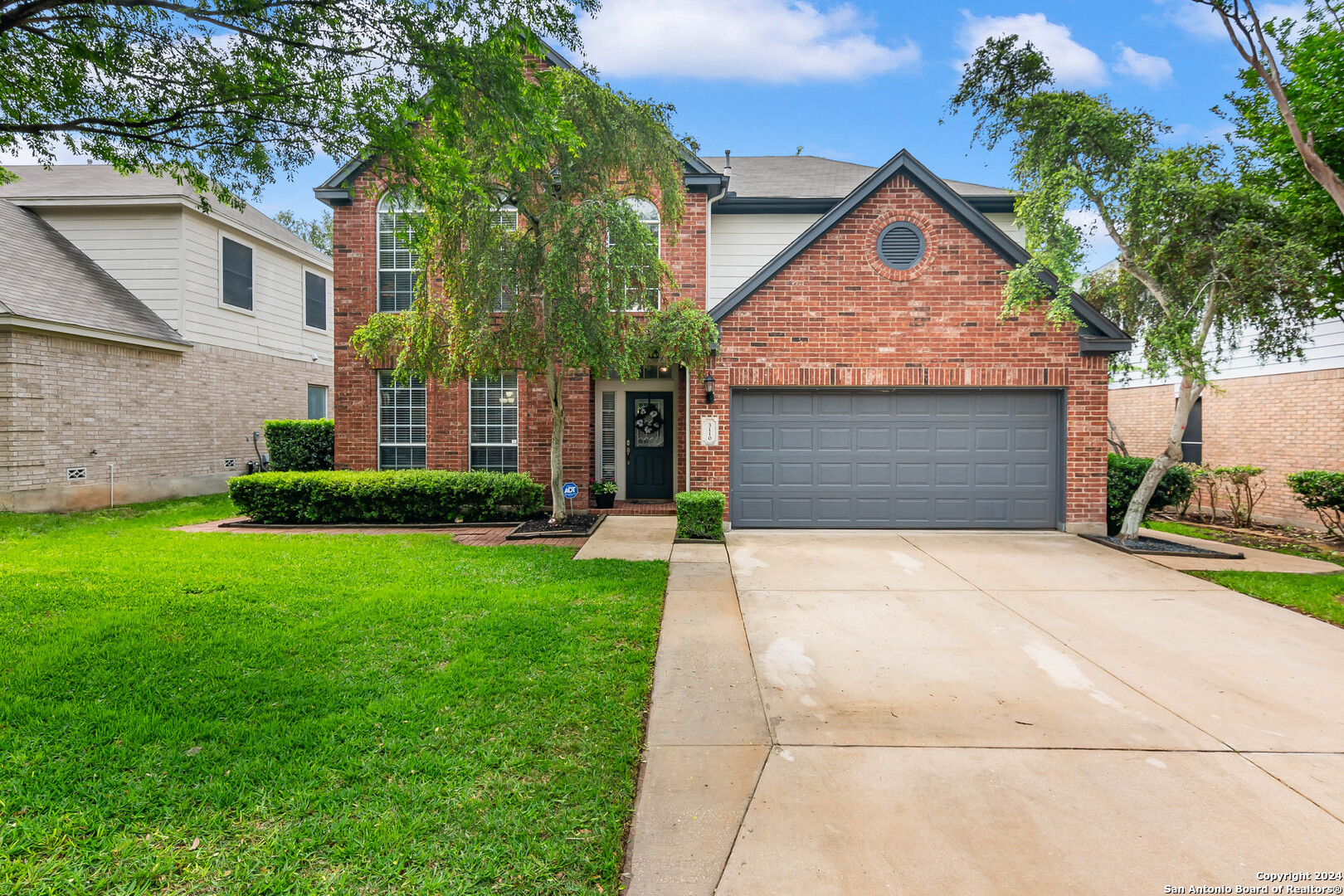 a front view of a house with a yard and garage