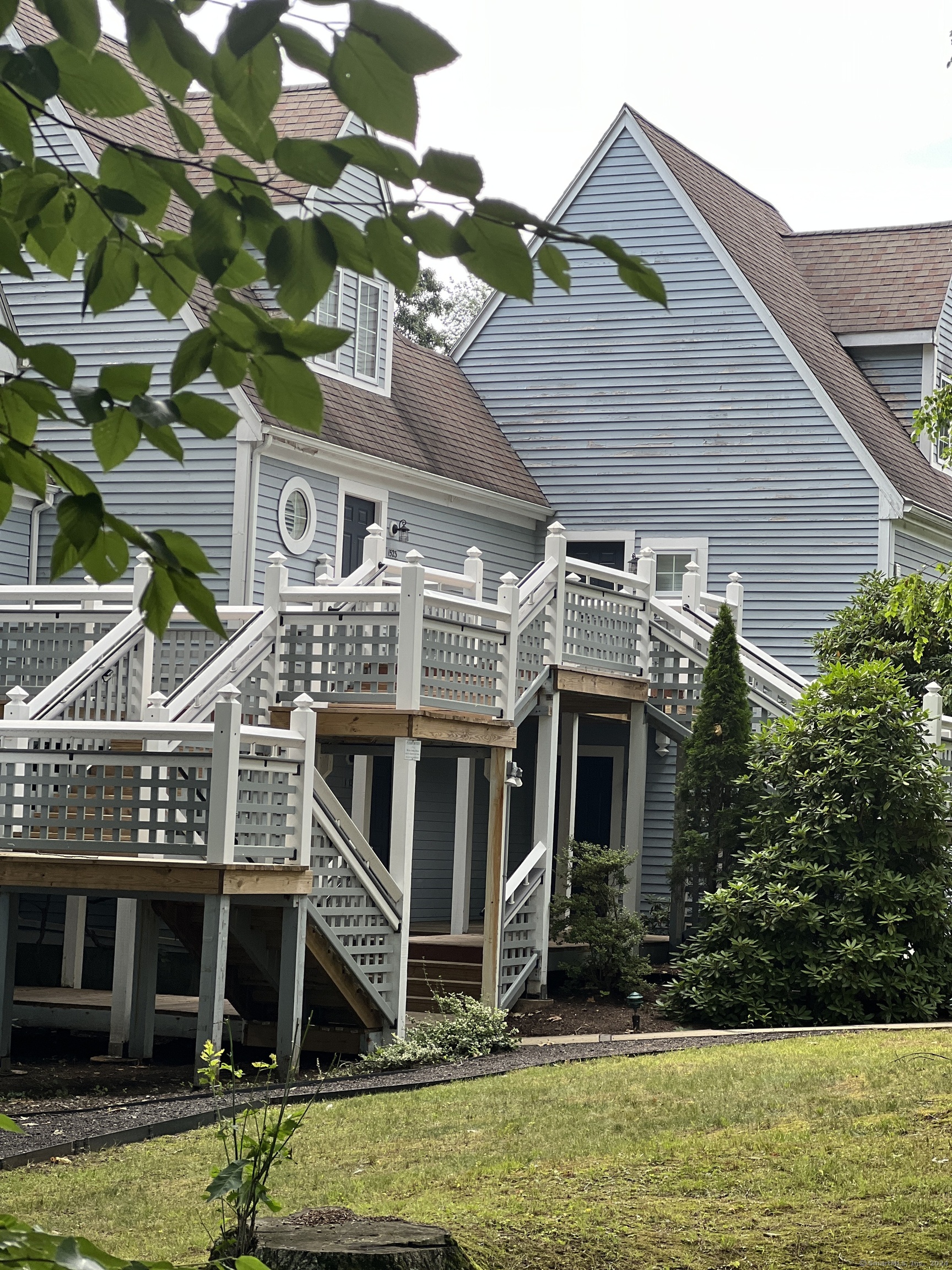 a front view of a house with a yard and swimming pool