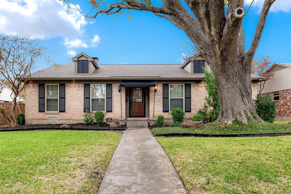 a front view of a house with a yard and porch