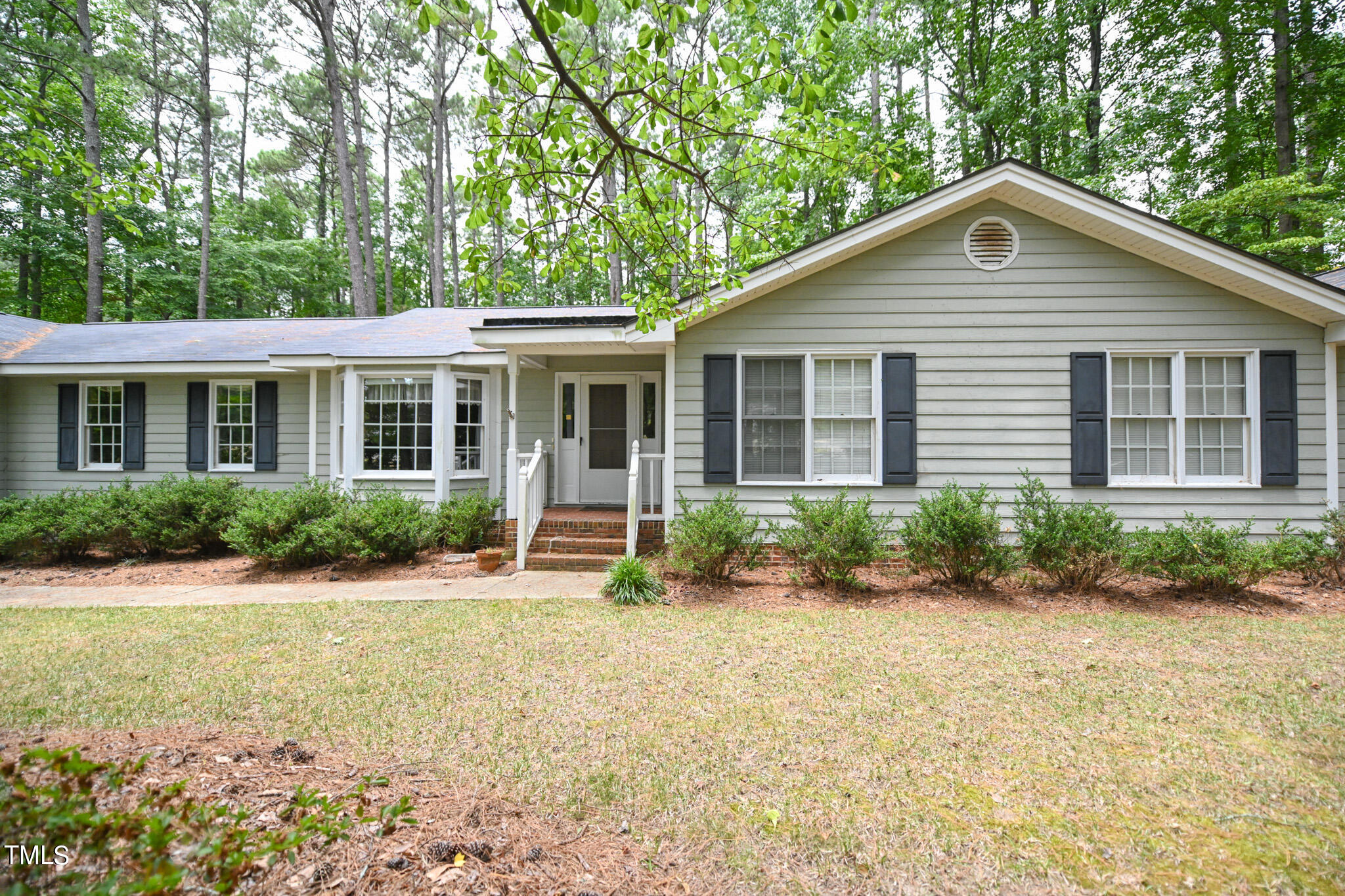 a front view of a house with a yard and porch