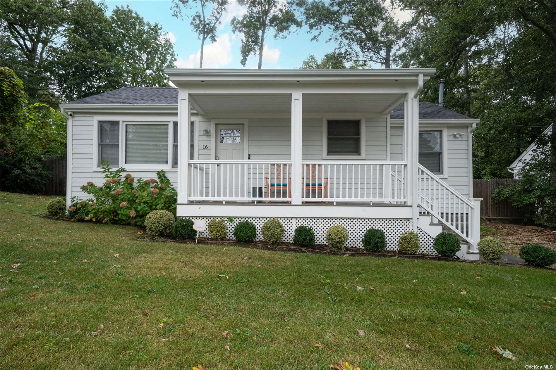 a front view of a house with a garden