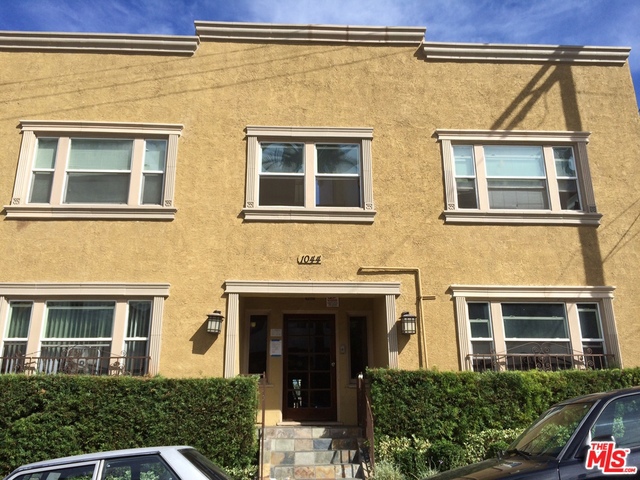 a view of a brick building next to a yard