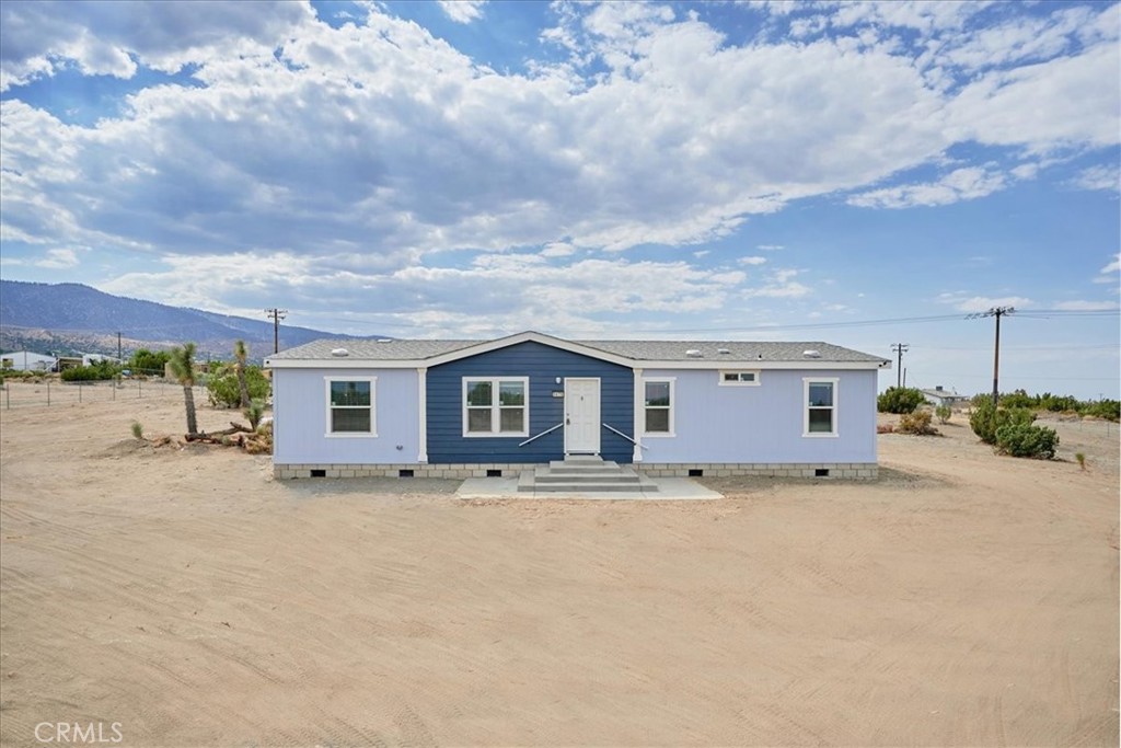 a big house with a large parking space and a street view