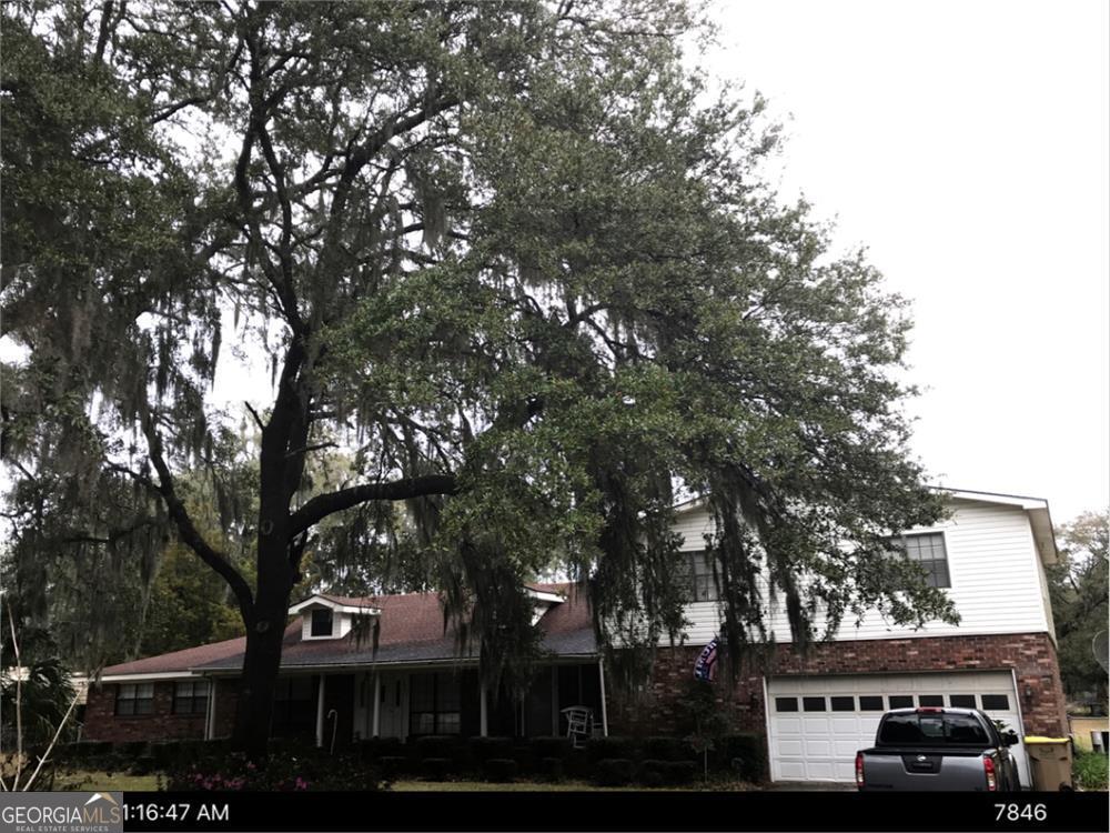 a front view of a building with trees