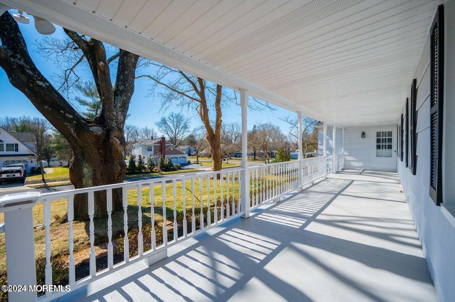 a view of balcony with wooden floor and fence