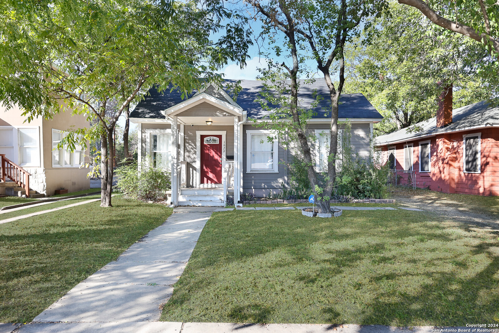 a front view of a house with a yard