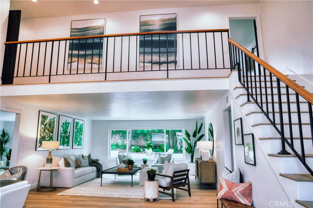 a living room with furniture tv and a large window