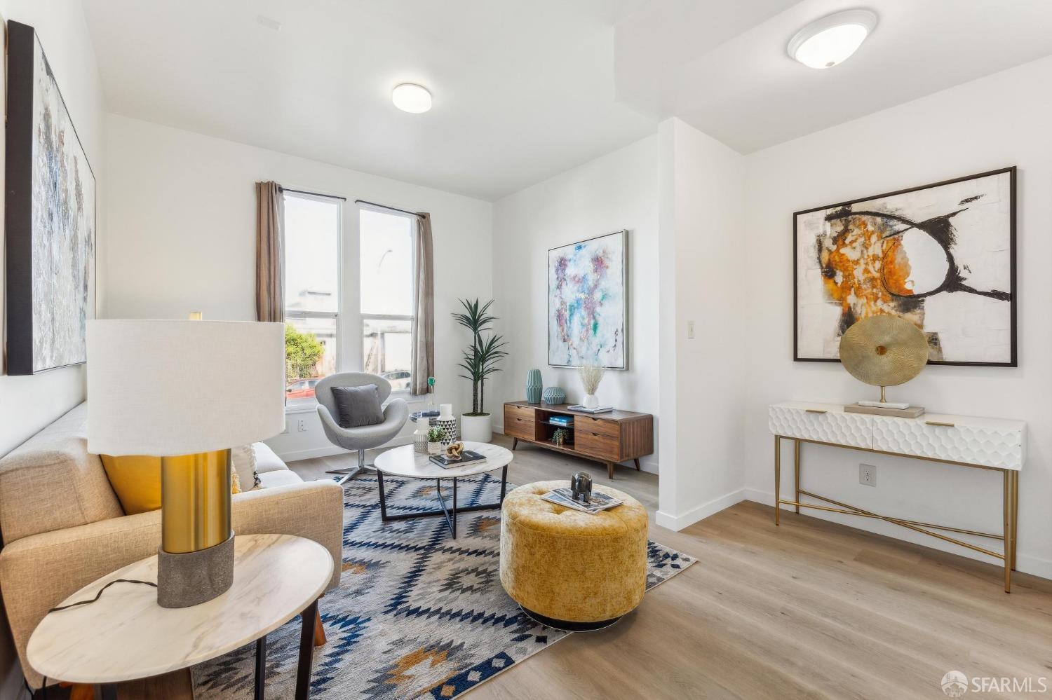 a living room with furniture and painting on the wall