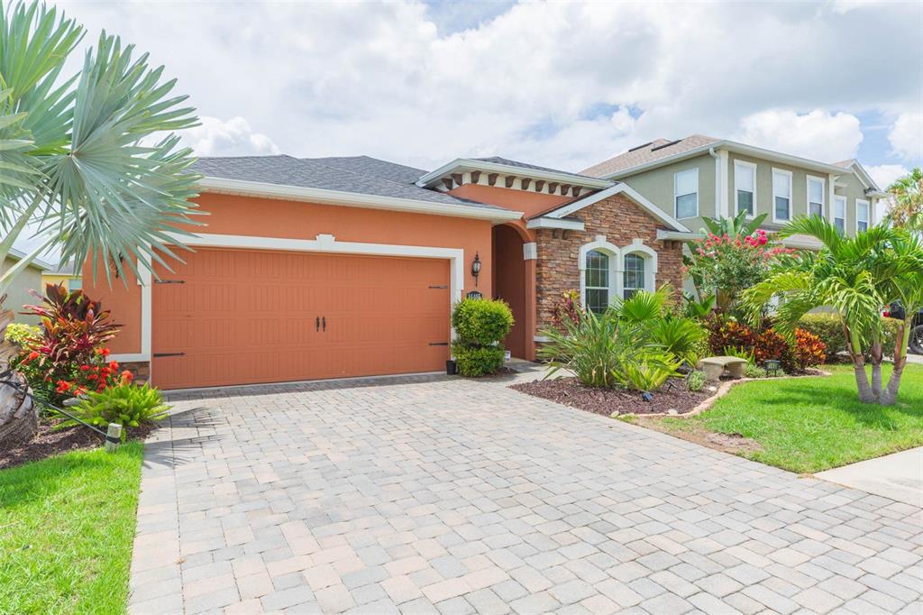 a front view of a house with a yard and a garage